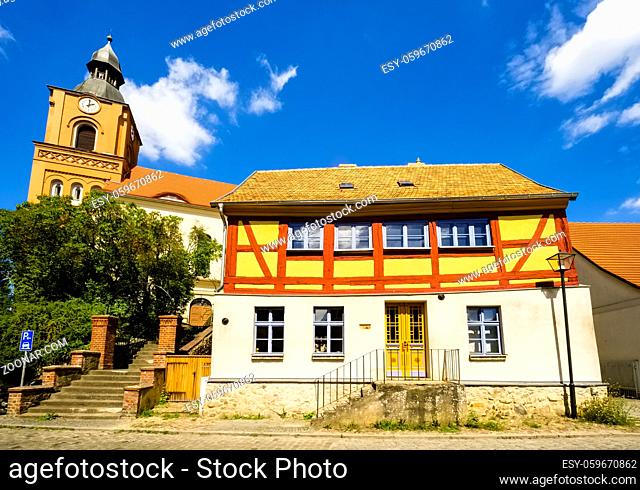 Half-timbered house in front of Parish church in Buckow, Brandenburg, Germany