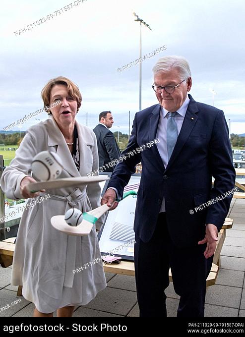 29 October 2021, Ireland, Limerick: Federal President Frank-Walter Steinmeier and his wife Elke Büdenbender play with hurling bats and balls during a visit to...