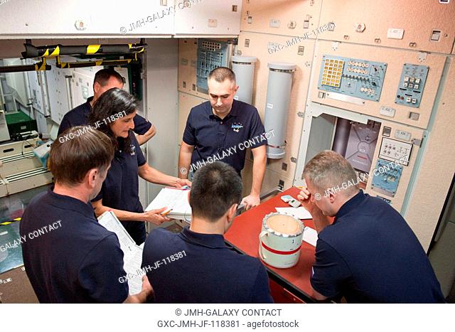 Expedition 323334 crew members participate in an emergency scenario training session in an International Space Station mock-uptrainer in the Space Vehicle...
