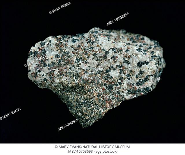 A granular rock composed of white calcite, dull green willemite, red zincite and black franklinite (Zinc Iron Manganese Oxide)