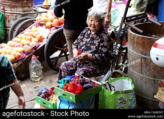 China, Suzhou, old woman in the market