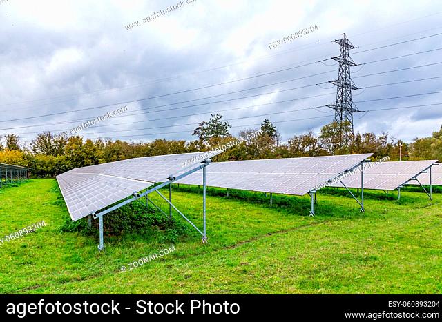 Modern power solar panels and high voltage post in a Dutch landscape