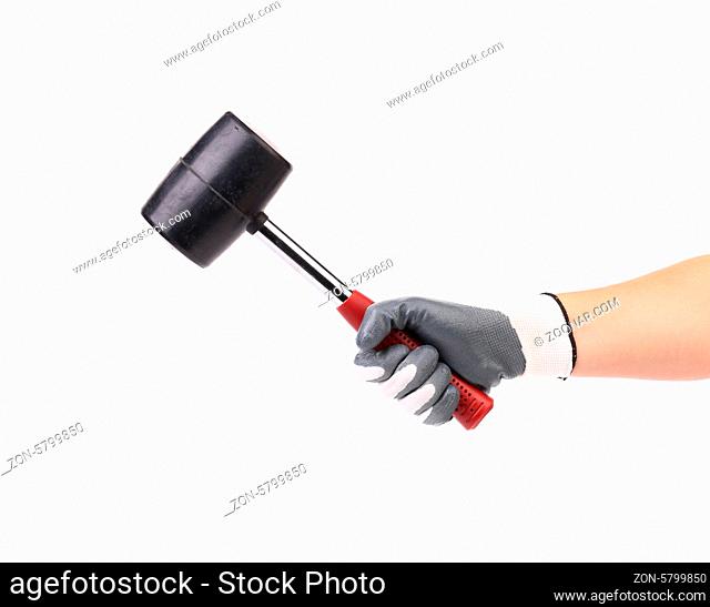 Hand in glove holding black hammer. Isolated on a white background