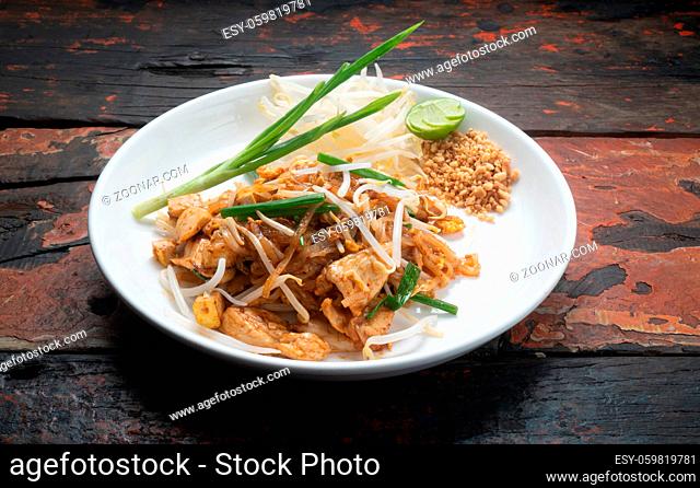 Top view Thai food Pad Thai chicken isolated on rustic wooden table