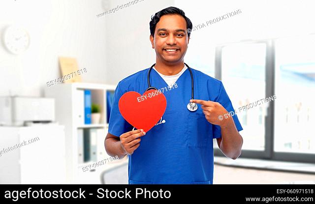 happy male doctor with red heart and stethoscope