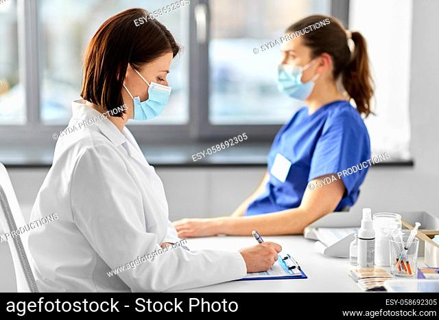 doctor with clipboard and nurse at hospital