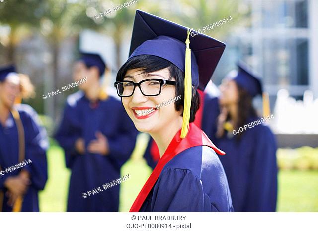Smiling graduate standing outdoors