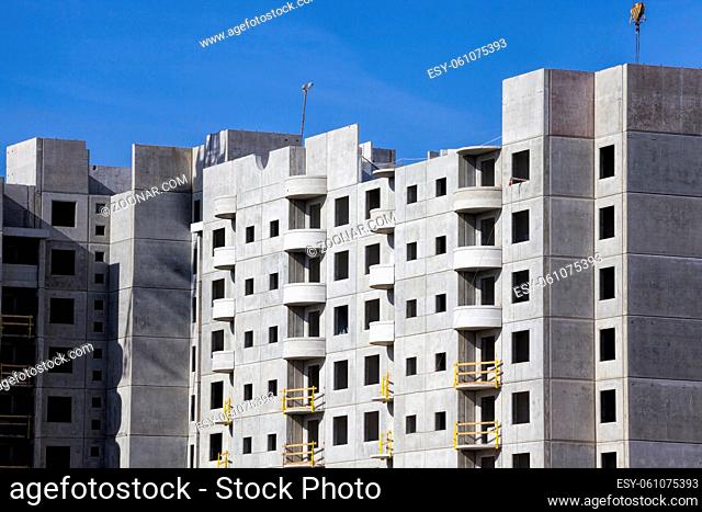 unfinished from large reinforced concrete slabs multi-storey residential house for people, photo from the construction site