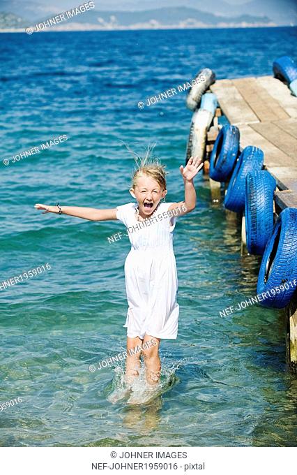 Girl jumping from jetty