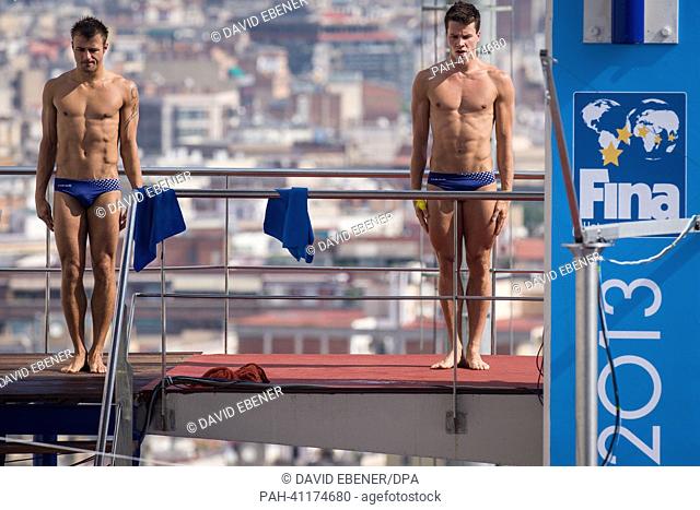Sascha Klein (L) and Patrick Hausding of Germany prepare for a jump during the men's 10m Synchro Platform diving preliminaries of the 15th FINA Swimming World...