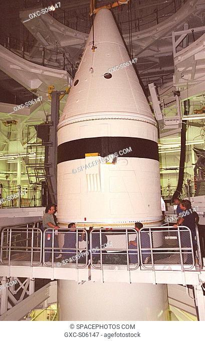 06/29/2000 --- Workers in the Vehicle Assembly Building check the connections on the forward section of a solid rocket booster SRB being mated to the rest of...
