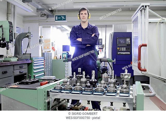 Germany, Young mechanic working in crafts workshop