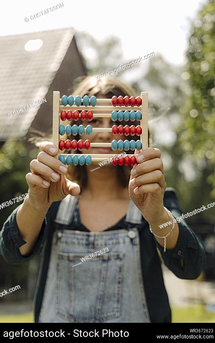 Young woman holding an abacus