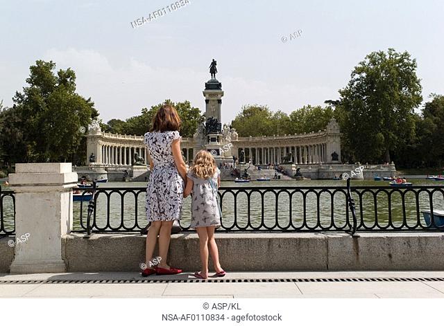 Mother and daughter looking at monument in Madrid Spain
