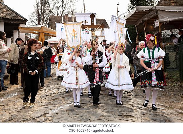 Easter in Hollokoe an UNESCO world heritage site in Hungary  Easter procession lead by young girls and boys in traditional folk costumes  Easter is celebrated...