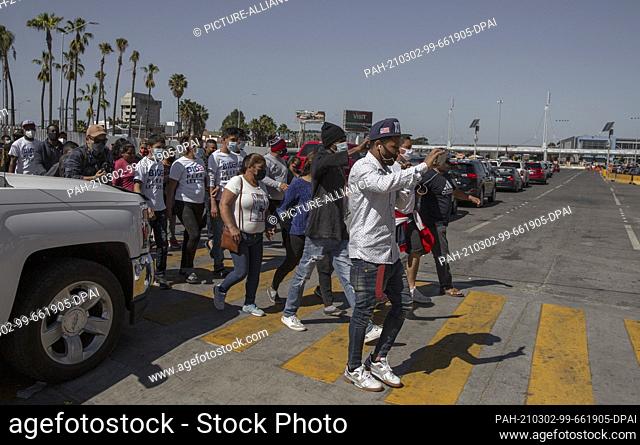 02 March 2021, Mexico, San Ysidro: Migrants from different backgrounds make their way to the border crossing. The migrants asked the new US administration for...