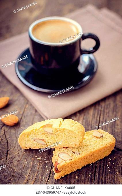 Good morning concept - breakfast frothy espresso coffee accompanied by delicious Italian almond cantuccini biscuits. Traditional italian biscotti cantuccini on...