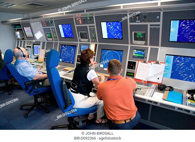 Air Traffic Control Tower Operators watching radar screens at East Midlands Airport