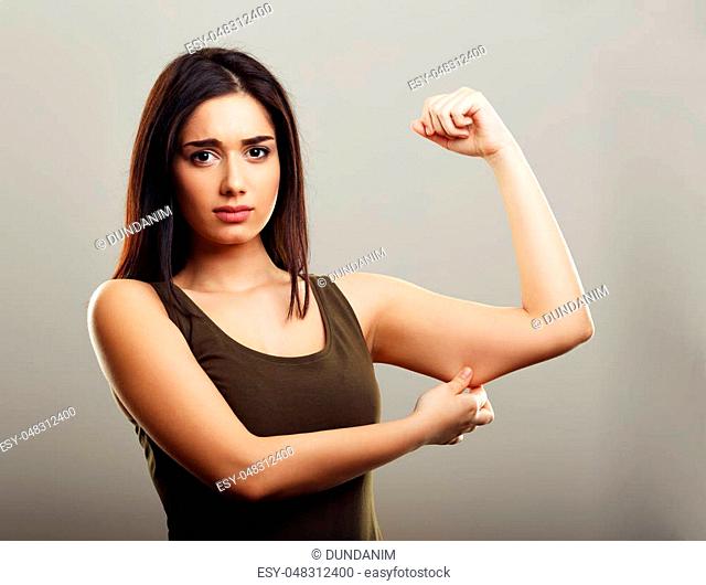 Young woman pinching arm fat flabby skin