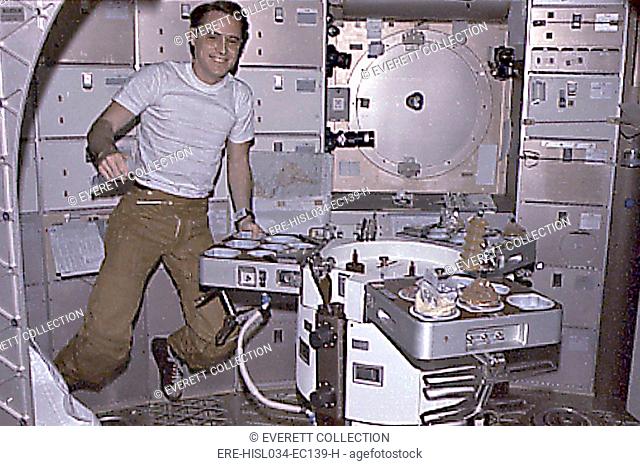 Skylab 4 Astronaut Ed Gibson preparing his meal aboard the Skylab space station. Skylab 4 mission lasted 84 days, testing the effects of prolonged zero gravity