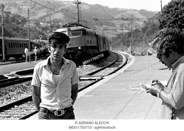 A stationmaster interviewed by a journalist. A journalist interviews the stationmaster of the San Benedetto Val di Sambro station