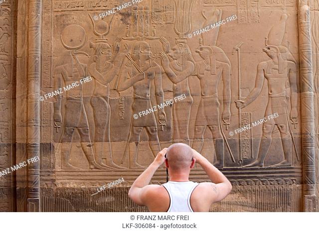 Tourist taking a photograph in front of the Temple of Kom Ombo, Egypt, Africa
