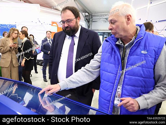 RUSSIA, MOSCOW - DECEMBER 20, 2023: Russia's Digital Development, Communications and Mass Media Minister Maksut Shadayev (L) visits a stand of the Russian...