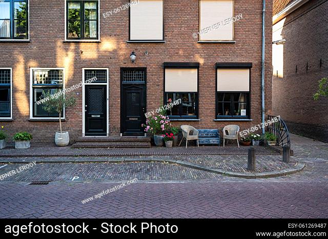 Zaltbommel, Gelderland, The Netherlands - 07 12 2022 - Traditional house facade with a bench and seats in front