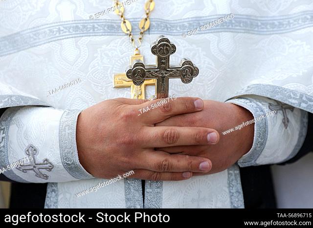 Russia. Orthodox cross in the hands of the priest. Erik Romanenko/TASS