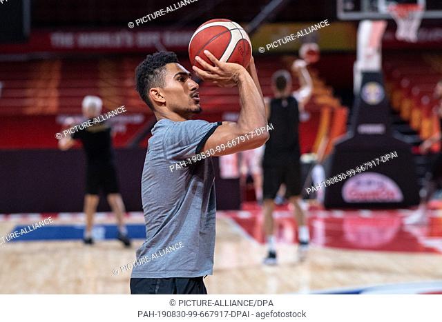 30 August 2019, China, Shenzhen: Basketball, WM, Germany, Training: Germany's Maodo Lo throws a ball at the basket after a non-public training of the national...