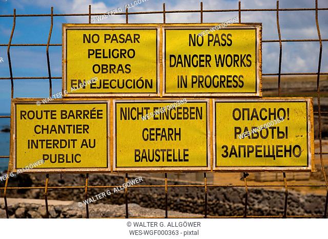 Spain, Tenerife, five construction site signs in different languages with spelling mistakes