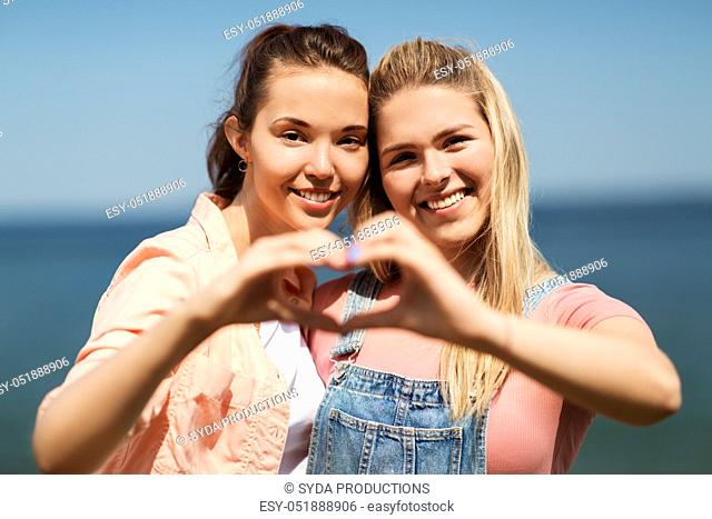 teenage girls or best friends at seaside in summer