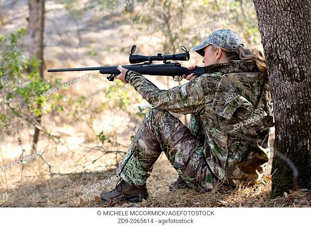 A pretty blonde hunter takes aim