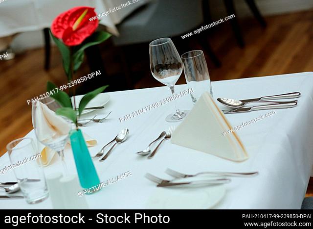 16 April 2021, Saxony-Anhalt, Stolberg: A table set at the Naturressort Schindelbruch. As part of a model experiment, the Ritter von Kempski Privathotels open...