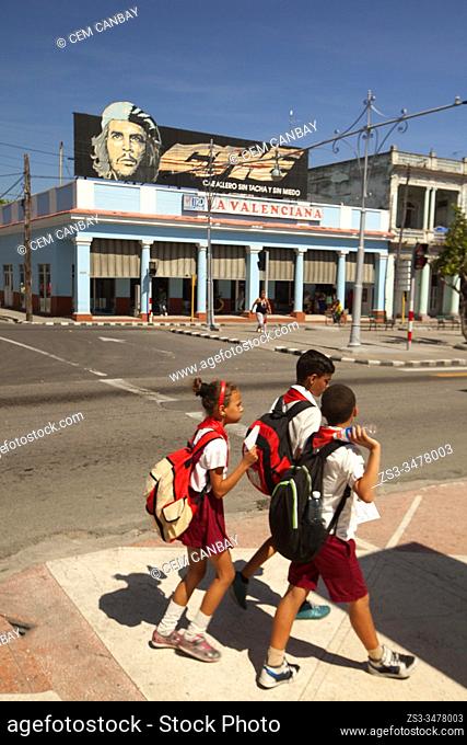 Students wearing uniform walking in the street at the town center, Cienfuegos, Cienfuegos Province, Cuba, West Indies, Central America