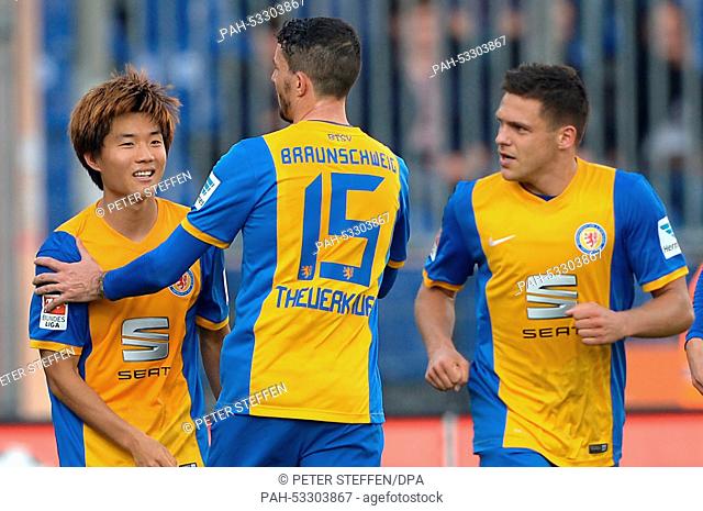 Braunschweig's Seung-Woo Ryu (L) celebrates his 1-0 goal with his teammates Norman Theuerkauf and Mirko Boland (R) during the German 2nd Bundesliga soccer match...