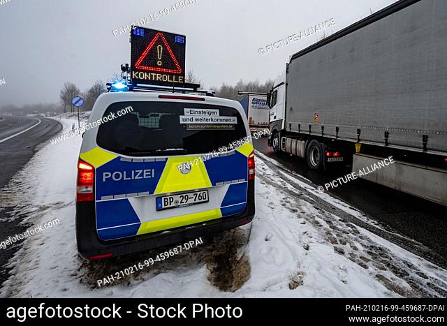 16 February 2021, Bavaria, Waidhaus: A police car announces a check at the German-Czech border in the early morning. Germany's tightened entry rules at the...
