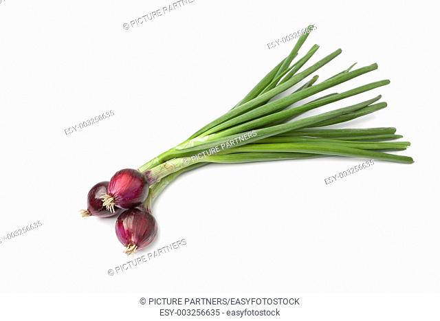 Fresh red raw onions on white background