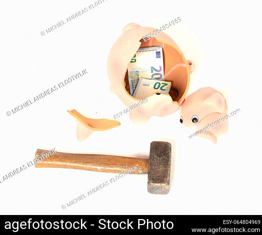 Hammer breaking piggy bank isolated on white
