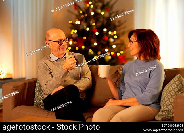 senior couple drinking tea at home on christmas