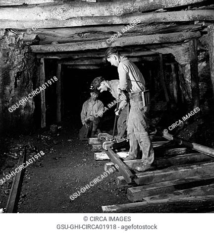 Three Miners Laying Track in Montour No. 4 Mine of Pittsburgh Coal Company, Pittsburgh, Pennsylvania, USA, John Collier for Office of War Information