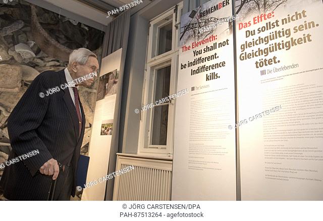 The Holocaust and Auschwitz survivor Felix Kolmer stands in front of a poster with the words ""The eleventh: You must not be indifferent