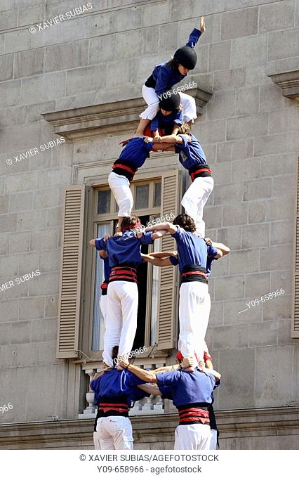 'Castellers' building human towers, a Catalan tradition. Mercè festivals. Plaça de Sant Jaume. Barcelona, Spain