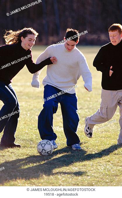 Teens playing soccer