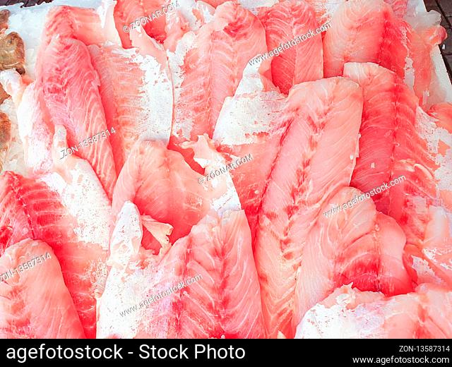 African perch fillet on ice for sale, Fish local market stall with fresh water fish, view from top