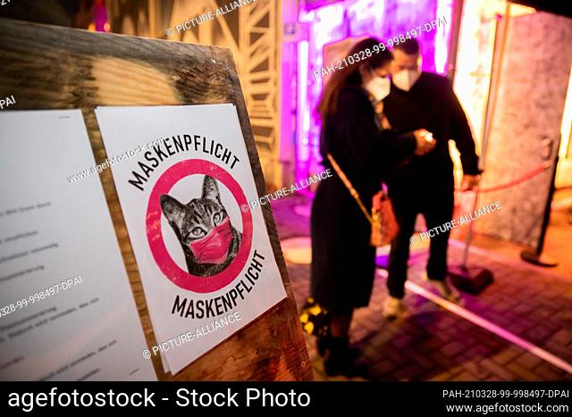 27 March 2021, Berlin: A sign with a depicted cat points out the mask obligation at the entrance to the ""Säälchen"" on the Holzmarkt before a test concert...