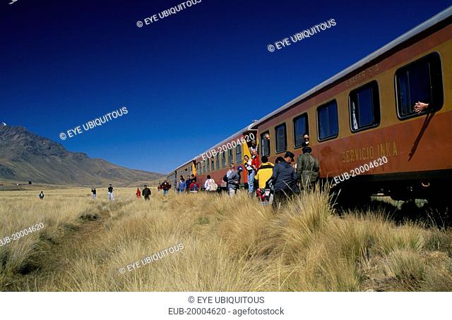Train stopped on the altiplano at the highest pass on the line between Puno to Cusco. People disembarking