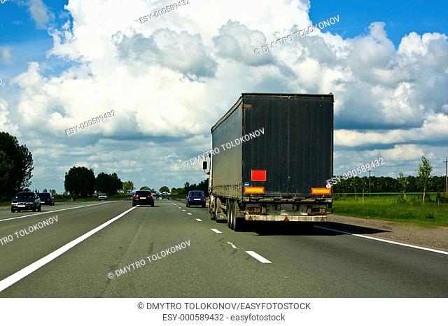 highway with transport under the blue sky