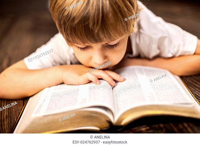 little boy studying the scriptures