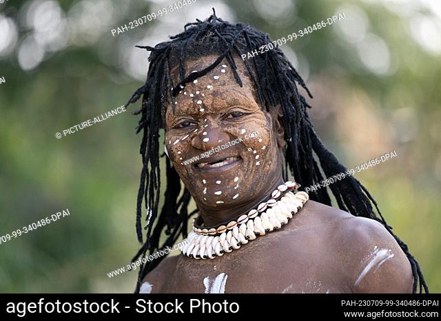 09 July 2023, Saxony, Crostwitz: Odjah Belenzi from the Congo stands at the edge of the procession for the 14th International Folklore Festival Lausitz on the...